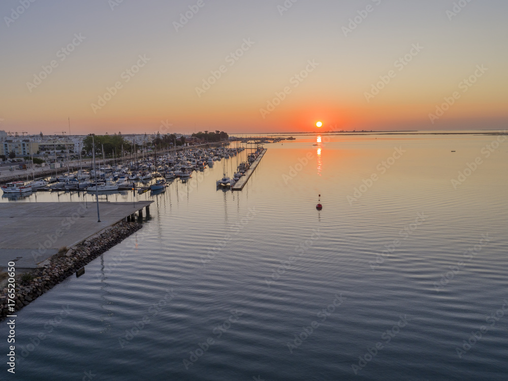 Sunrise aerial seascape view of Olhao Marina, waterfront to Ria Formosa natural park. Algarve.