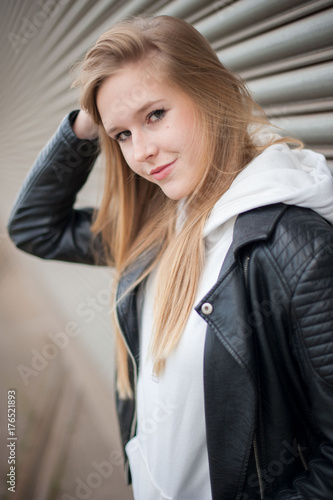 Beautiful blond austrian Girl in front of an Industrial Background