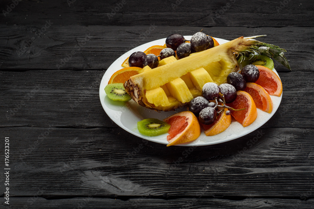 Fruit plate on a dark wooden background Fruit plate on a dark wooden background