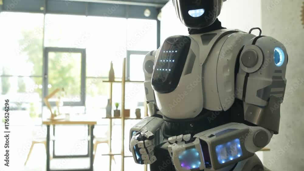 Modern robotic machine standing in office Modern robotic machine standing in office