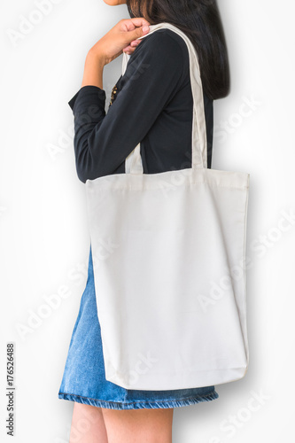 White tote bag mockup template cotton canvas fabric texture on girl shoulder (isolated with clipping path) on white background