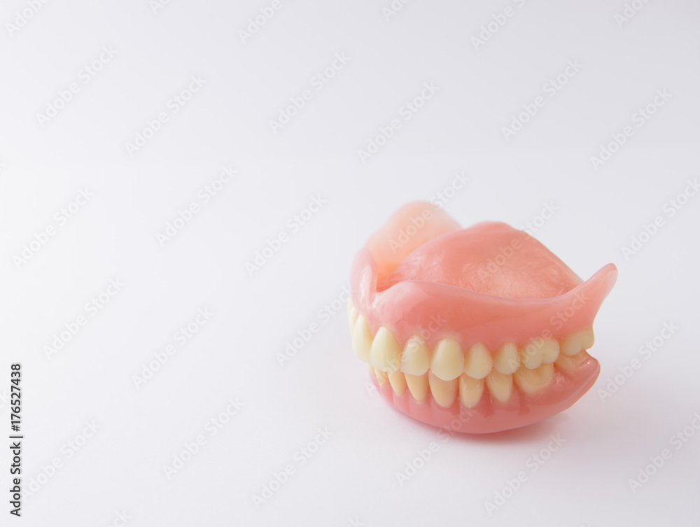 Obraz premium False teeth on white background