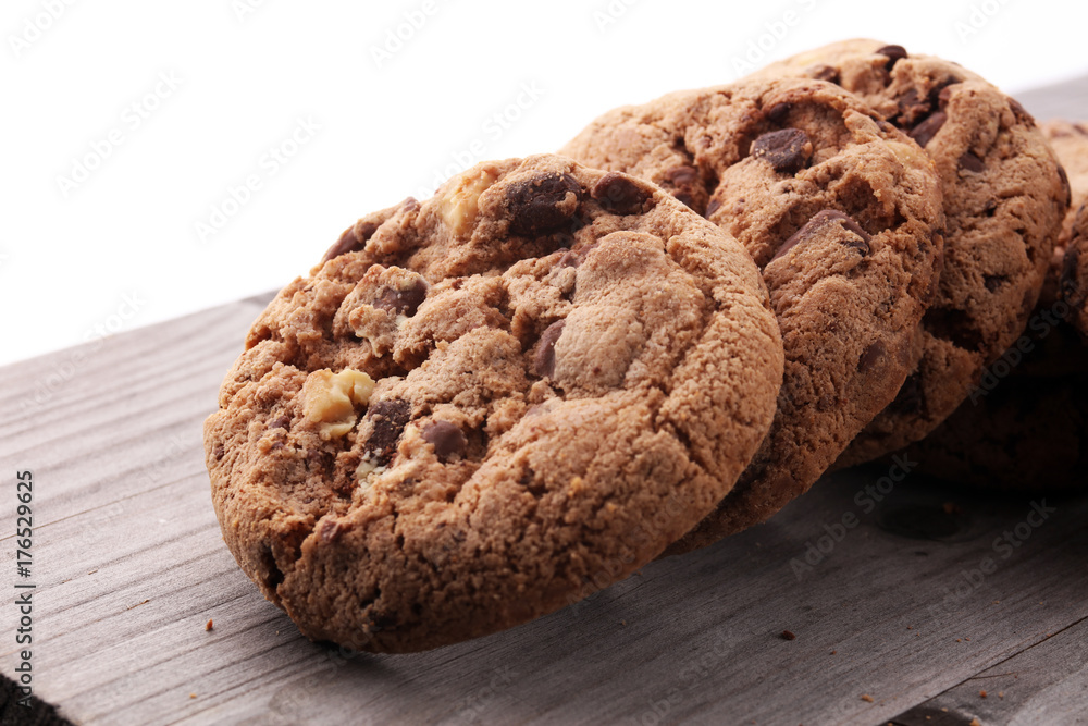 Fototapeta premium Chocolate cookies on wooden table. Chocolate chip cookies shot.