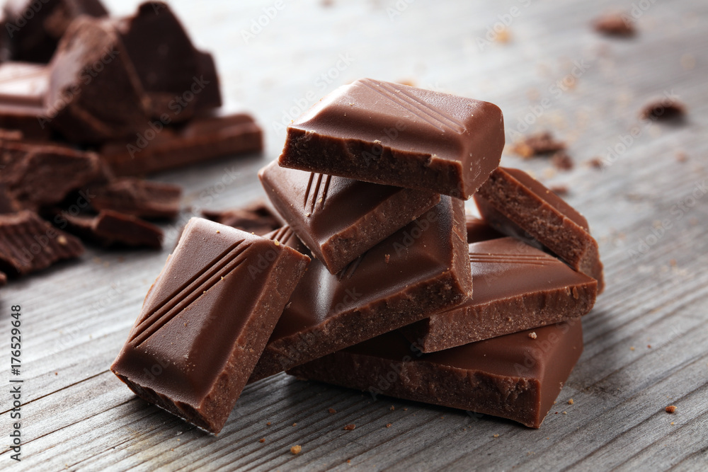 Dark Chocolate chunks and stacked broken chocolate bar. Dark Chocolate chunks and stacked broken chocolate bar.