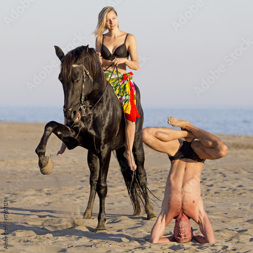 horsewoman and yogi on the beach