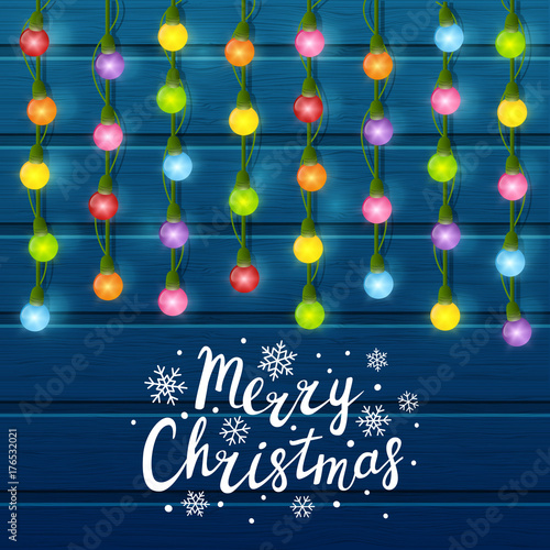 Christmas light bulbs on wooden background