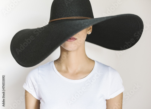 Young woman wearing a big black hat