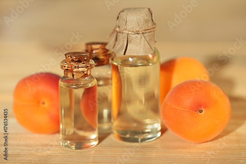apricot oil. Apricot oil in a transparent bottle on a wooden board background. Organic Natural Cosmetics Concept