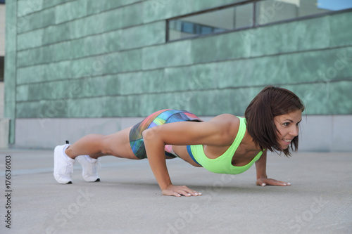 young strong athletic girl doing push-ups