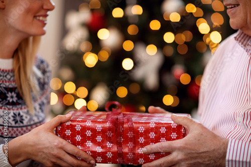father and daughter exchanging Christmas gifts.