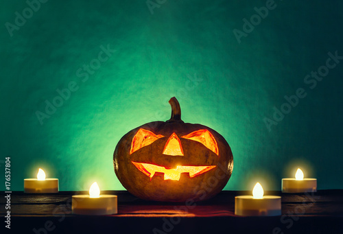 halloween pumpkin head with candle light in darkness spooky background