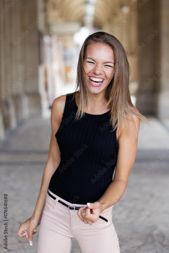 Young brunette woman laughing on jokes