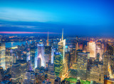 NEW YORK CITY - JUNE 9, 2013: Night aerial view of Midtown skyscrapers. New York attracts 50 million tourists every year