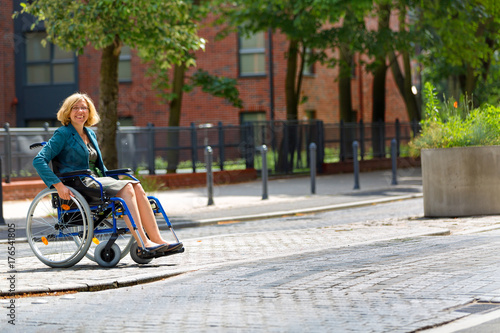 woman on wheelchair crossing the street