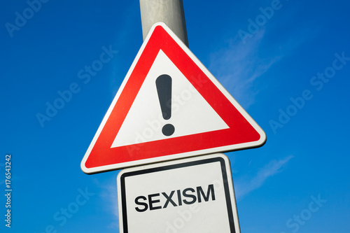 Sexism - traffic sign with exclamation mark to alert, warn caution - precaution and warning of violent and offensive attack and assault that is based on sex and gender