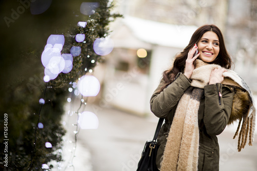 Smiling woman using phone i...