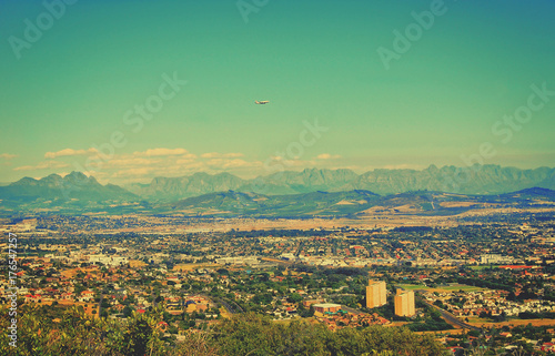 Wonderful vintage. Matte background. Aerial view at the city and mountains. Panoramic skyline. Amazing landscape. Retro postcard.