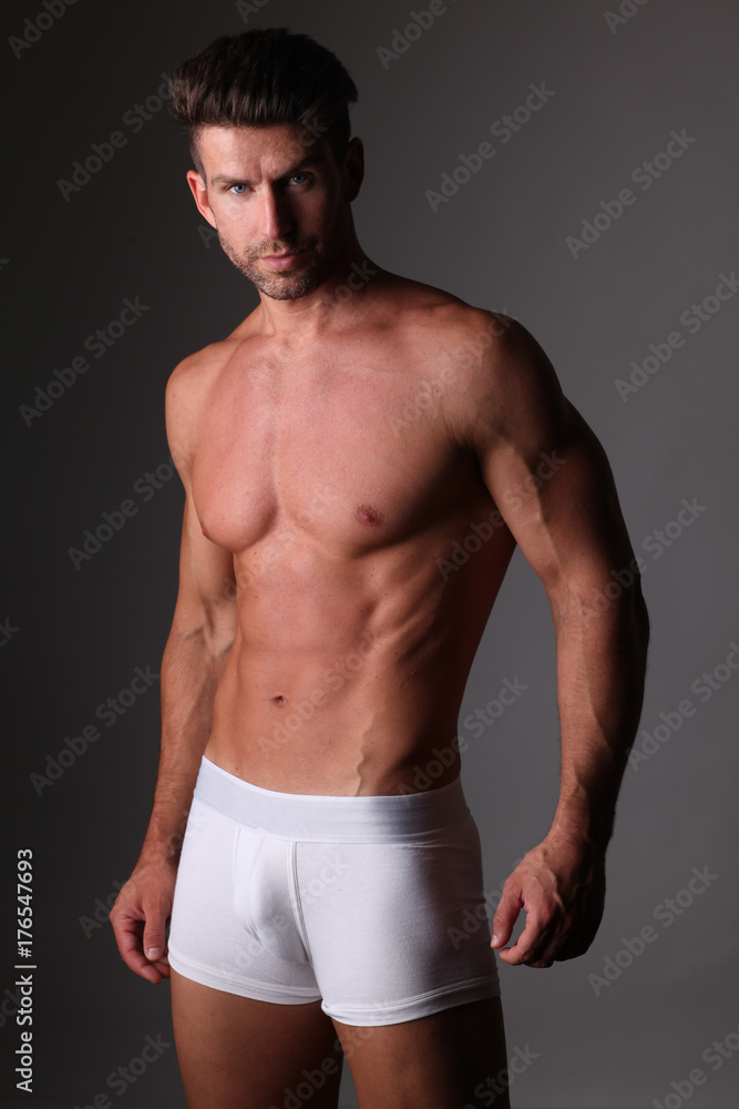 Fototapeta premium Young well build man is posing in white underpants.