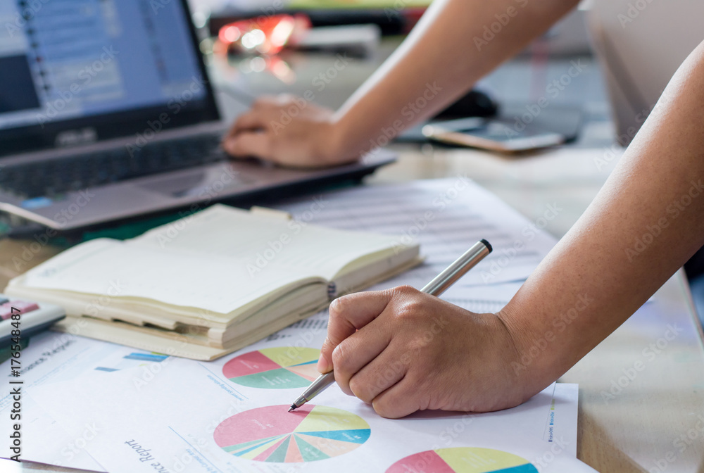 woman hand calculate cost and expenses and using laptop for search data result woman hand calculate cost and expenses and using laptop for search data result