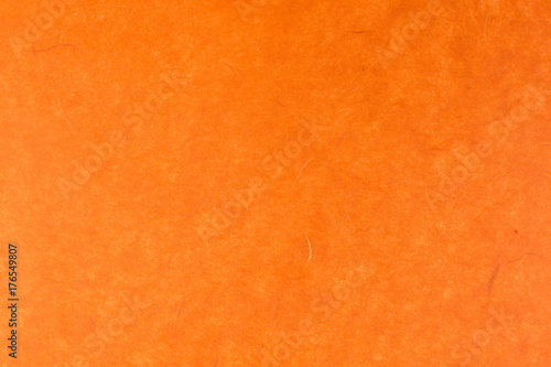 orange paper background with silk fibres photo