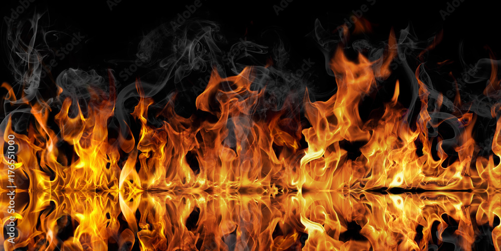 The texture of fire on a black background is reflected in a glossy table. The texture of fire on a black background is reflected in a glossy table.