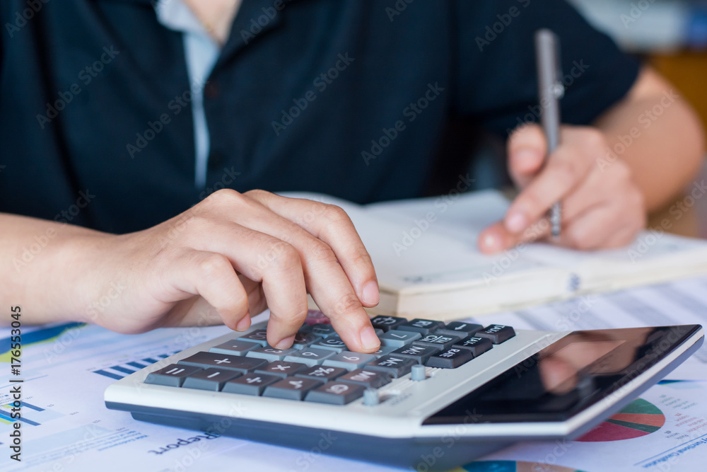woman hand using calculator and writing make note with calculate woman hand using calculator and writing make note with calculate