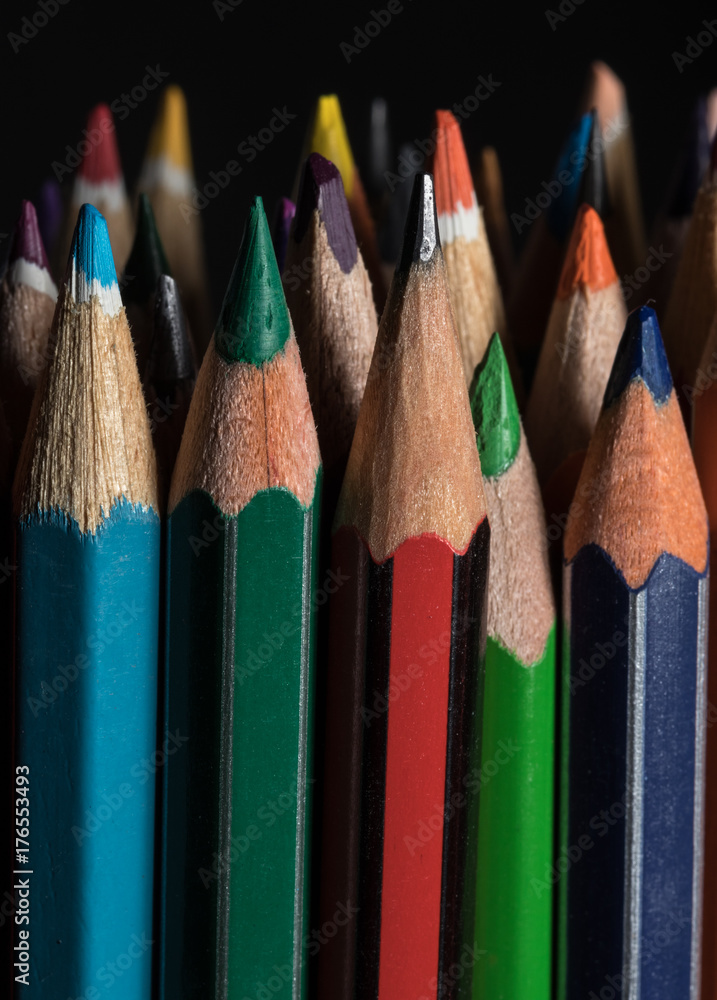 A set of colored pencils on black background A set of colored pencils on black background