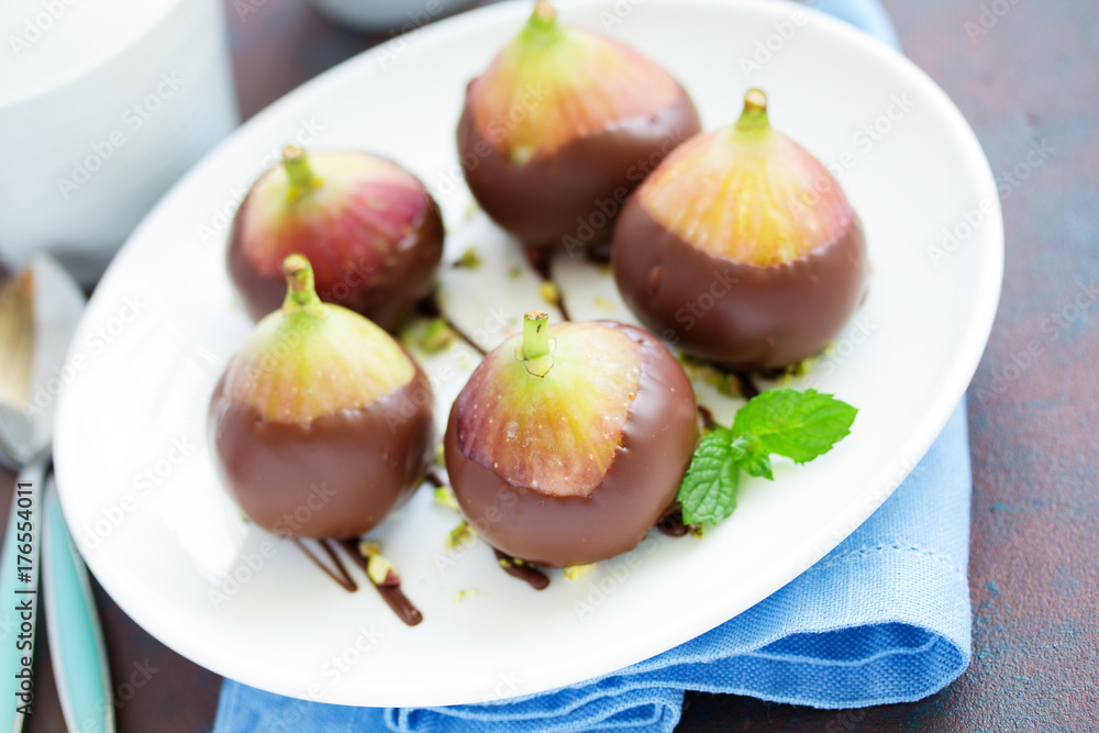 Dessert, fresh figs in chocolate with pistachios. Dessert, fresh figs in chocolate with pistachios.