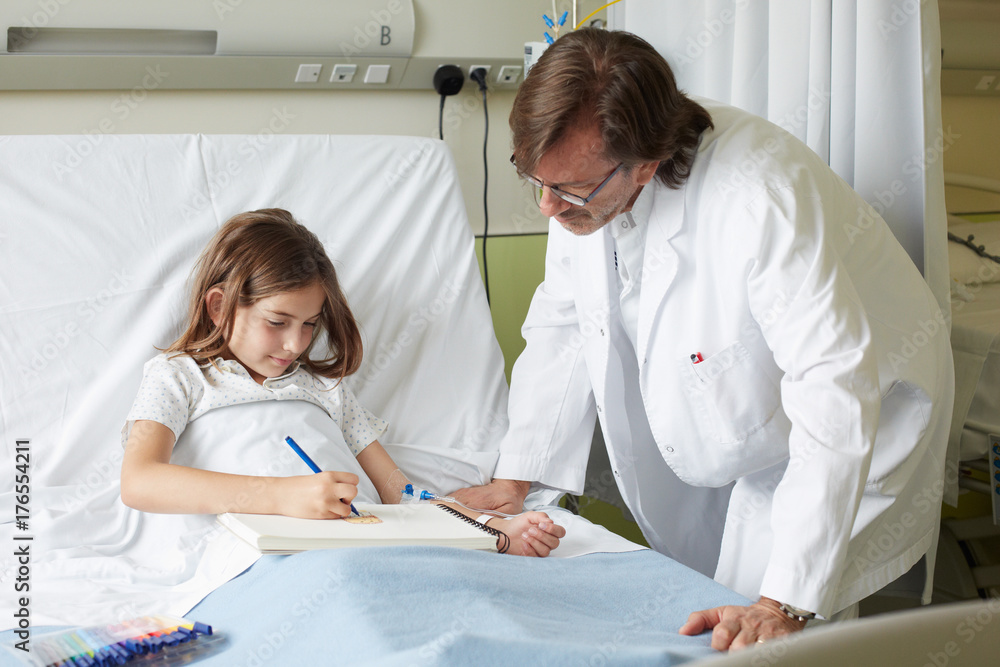 Relaxed moment in a hospital room with little girl patient and doctor Relaxed moment in a hospital room with little girl patient and doctor