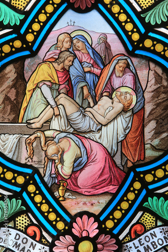 The descent from the cross and the entombment. Jesus Christ.Stained glass window. Shrine of Our Lady of la Salette.