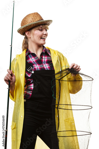 Happy woman holding fishing rod and keepnet photo