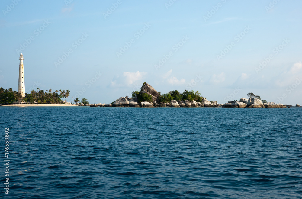 Fototapeta premium White lighthouse standing on an island in Belitung at daytime with no people around.