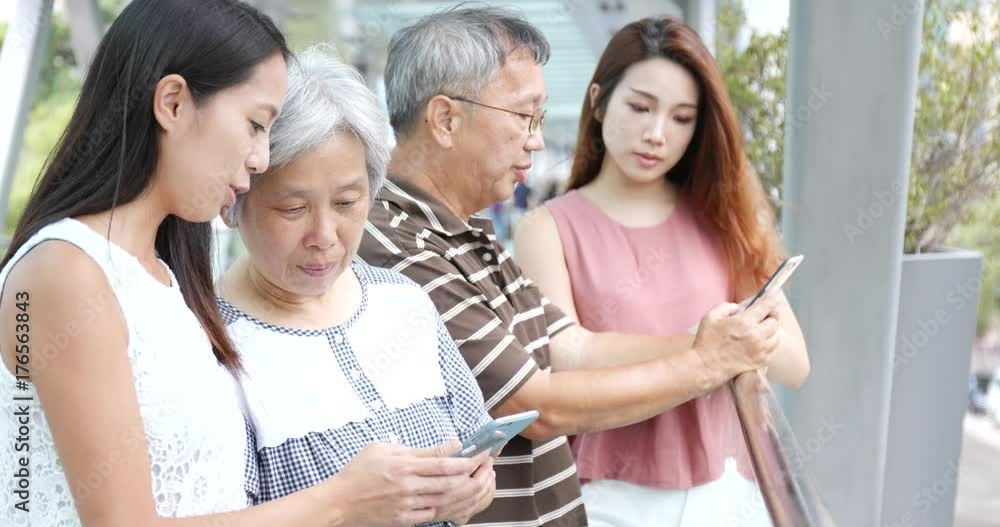 Family using mobile phone together