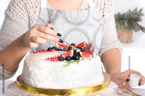 the woman decorates cake kanduriny photo