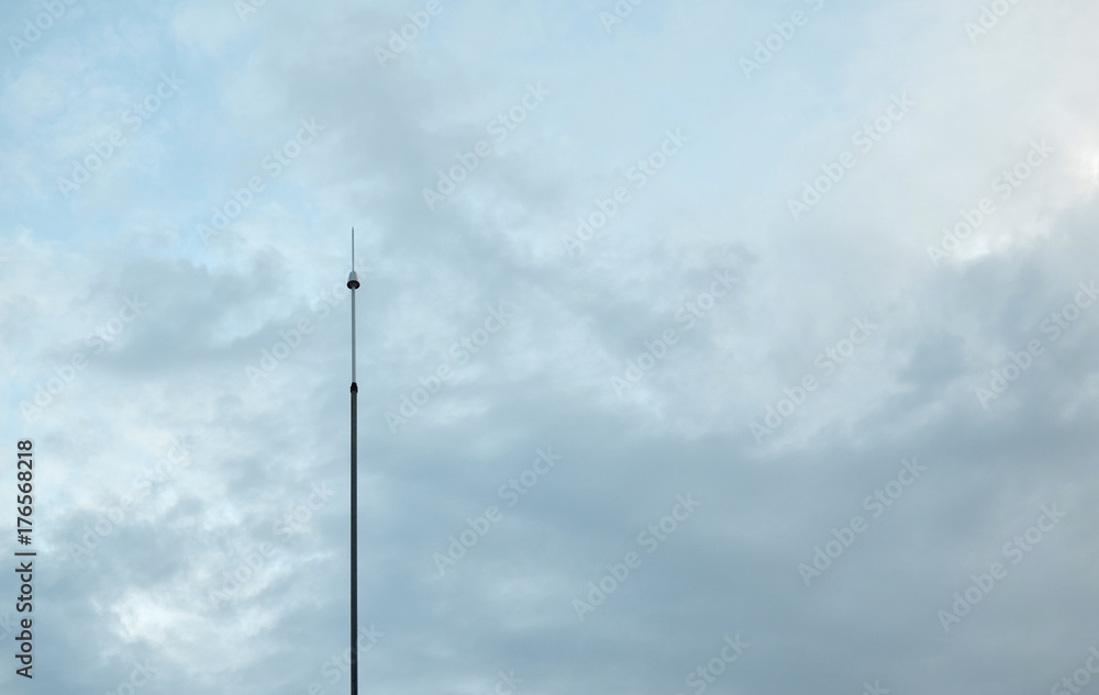 Lightning rod against sky with clouds above it Lightning rod against sky with clouds above it