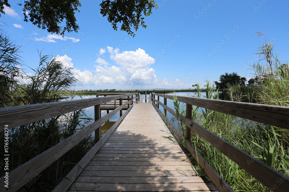 wood dock walkway in waterway