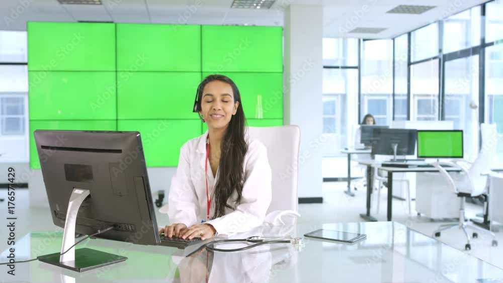 Healthcare worker assisting a patient over the phone, with green background Healthcare worker assisting a patient over the phone, with green background