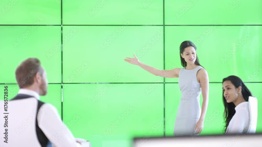 Business team in a meeting, woman interacting with green screen background Business team in a meeting, woman interacting with green screen background
