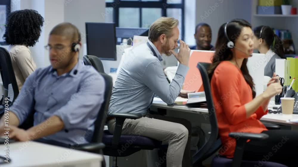 Fed up businessman sitting at his desk looking depressed Fed up businessman sitting at his desk looking depressed