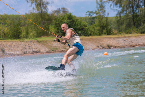 Man study wakeboarding on a blue lake
