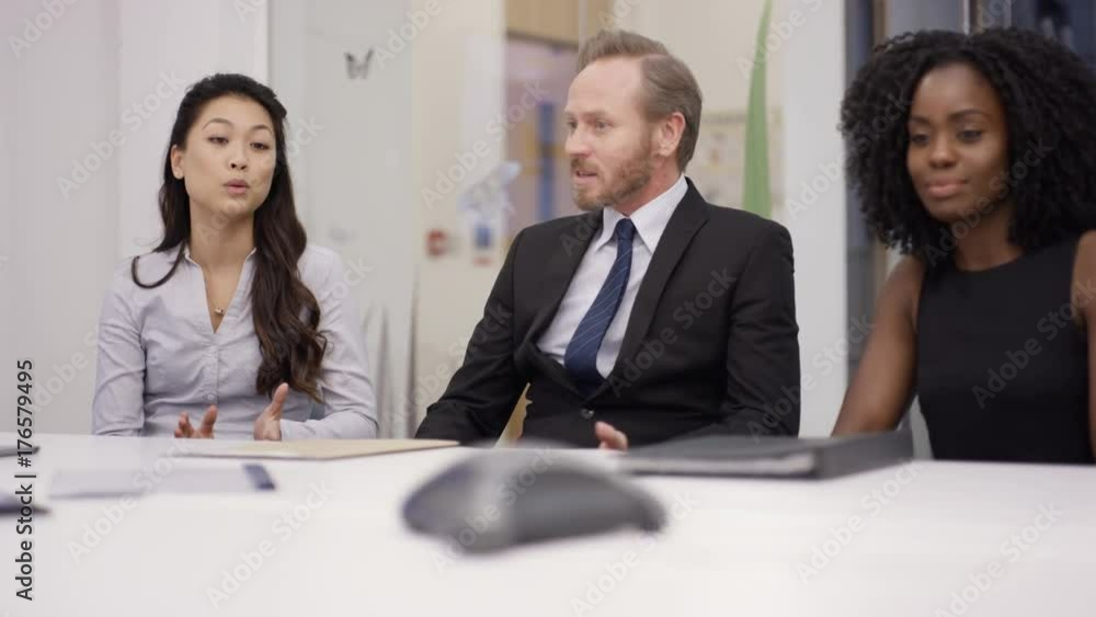 Business marketing team discussing technology gadget in a meeting Business marketing team discussing technology gadget in a meeting