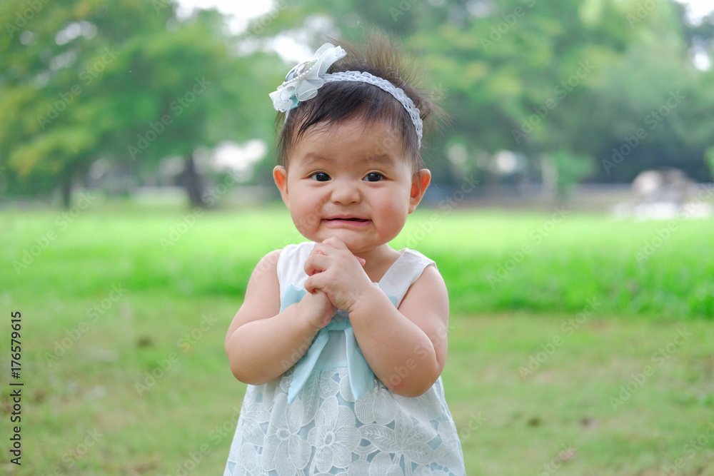 Asian Adorable baby girl playing in park. Beautiful smiling cute baby Asian Adorable baby girl playing in park. Beautiful smiling cute baby