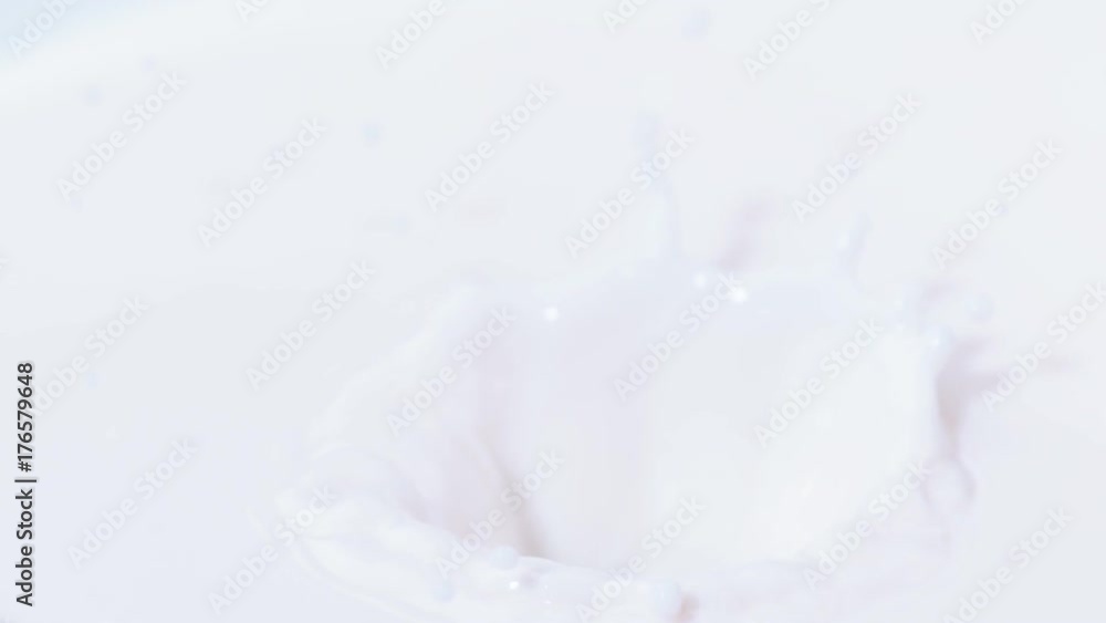 Fresh red strawberry dropping into bowl of cream, close up & in slow motion Fresh red strawberry dropping into bowl of cream, close up & in slow motion