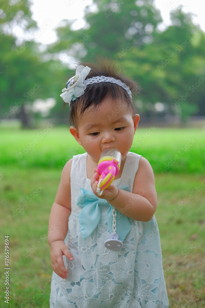 Asian Adorable baby girl playing in park. Beautiful smiling cute baby Asian Adorable baby girl playing in park. Beautiful smiling cute baby