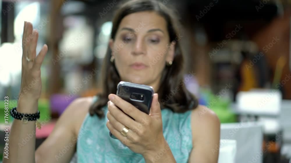 Irritated woman checking time and waiting for someone in restaurant, steadycam shot
