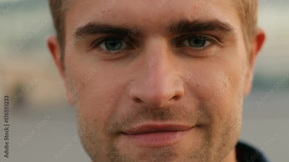 Portrait of a confident young man looking into the camera. Blurred background. Close up Portrait of a confident young man looking into the camera. Blurred background. Close up