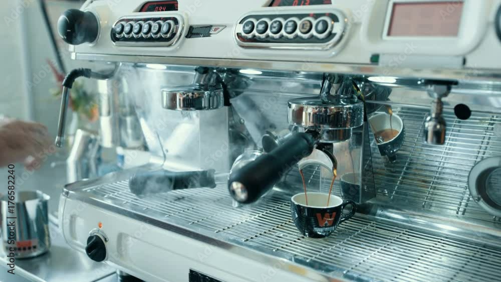 Close up hands of cafe barista preparing fresh espresso from coffee machine Close up hands of cafe barista preparing fresh espresso from coffee machine