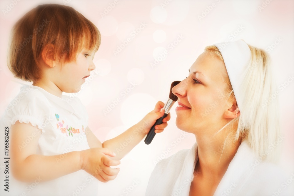 Composite image of beaming mother taking care of her child Composite image of beaming mother taking care of her child