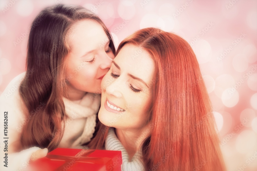 Composite image of mother and daughter with gift Composite image of mother and daughter with gift