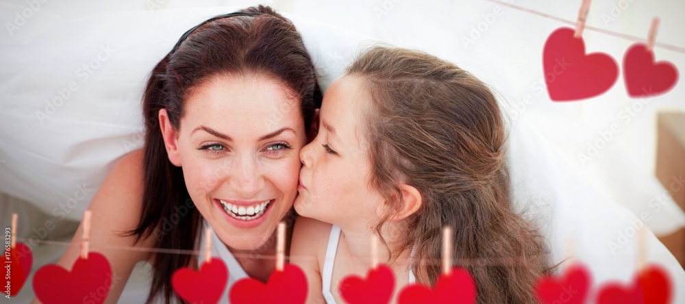Composite image of mother and her daughter having fun on bed Composite image of mother and her daughter having fun on bed